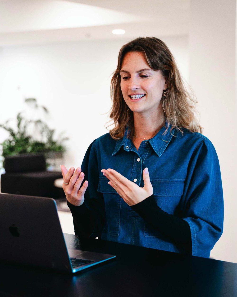 A colleague talking through work at a desk