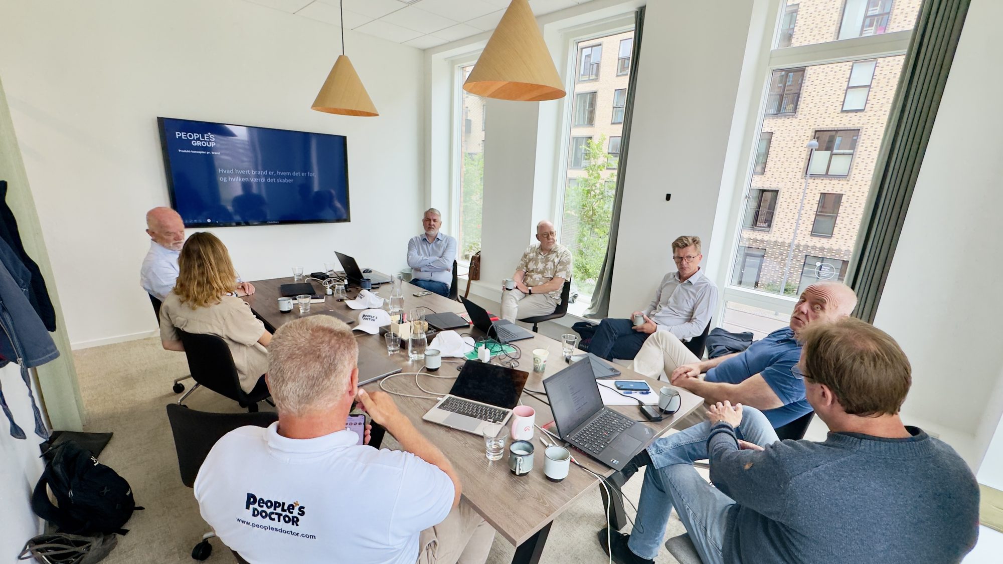 The People's Group team around a table at a strategy offsite in Copenhagen